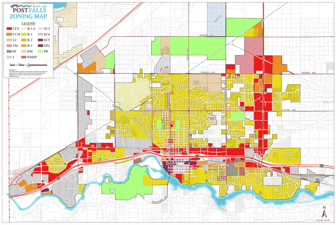 City of Post Falls zoning map. Colored parcels are zoned by the city; the white pockets inside the city boundary are unincorporated Kootenai County land.